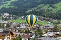 Kirchberg in Tirol, Tirol/Austria - September 25 2018: A hot-air balloon flying very low over the houses and buildings of the Royalty Free Stock Photo