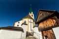 Kirchberg in Tirol, Tirol/Austria - September 18 2018: The white famous church and a wooden structure next to the graveyard shot Royalty Free Stock Photo