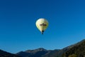 Kirchberg in Tirol, Tirol/Austria - September 27 2018: A white Relfex branded hot-air balloon flying above the Austrian landscape Royalty Free Stock Photo