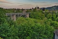 Kirchenfeldbrucke Bridge over Aare river with Bernisches Historisches Museum / Einstein Museum and Swiss Alps in background