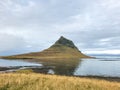 Kirkjufell in Iceland famous mountain reflecting in lake during cloudy day Royalty Free Stock Photo