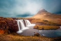 Kirkjufell mountain behind Kirkjufellfoss waterfall in Iceland