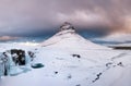 Kirkjufell mountain, Iceland. Kirkjufellsfoss waterfall. Winter landscape. Snow and ice. Royalty Free Stock Photo