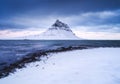 Kirkjufell mountain, Iceland. Winter landscape. The mountain and the ocean. Snow and ice.