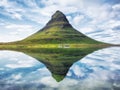 Kirkjufell. Mountains in the Iceland. Reflection on the water surface. Natural landscape at the summer.