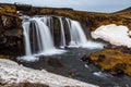 Kirkjufellsfoss waterfalls surrounded by melting snow