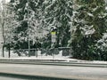 School zone speed limit sign on a snowy, icy road after a big snow storm Royalty Free Stock Photo