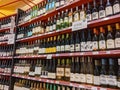 Kirkland, WA USA - circa March 2021: Angled view of the wine aisle, displaying a wide variety of wine styles on red shelving