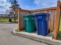 Street view of trash and recycling cans at a park near Lake Washington on a sunny day