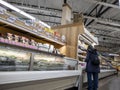 Kirkland, WA USA - circa September 2021: View of a woman shopping in the freezer aisle inside a Trader Joe`s grocery store Royalty Free Stock Photo