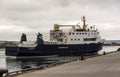 A vehicle and passenger ferry sailing out from the pier in Kirkwall harbour Scotland, UK.