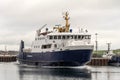 A vehicle and passenger ferry enters Kirkwall harbour entrance. Scotland, UK.