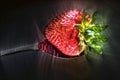 3D-Illustration Kirlian glow on strawberries with leaves on a plate in a glas bowl. Isolated on a white background