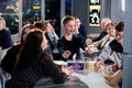 Kirov, Russia - April 18, 2019: People at tables in cafe or restaurant being glad something. Intellectual game indoors