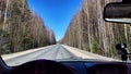 Kirov, Russia - April 06, 2023: View from the windshield of nature on autumn or spring sunny day and blurred hand of Royalty Free Stock Photo