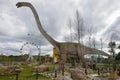 Mamenchisaurus is a herbivorous dinosaur in the childrens paleontologic park `Yurkin Park` in the cloudy afternoon