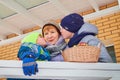 Kirov, Russia - January 19, 2019: Family resting outdoors in winter, grandmother with grandchildren near house in winter