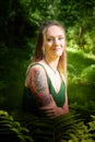 Kirov, Russia - June 29, 2022: Portrait of girl with Tattoo looking as peautiful seductive dryad. Pagan spirit of the