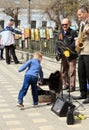 Kirov, Russia, 05.09.2014 Little boy putting money in an open case of street musicians Royalty Free Stock Photo