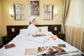 Kirov, Russia - March 02, 2019: Beautiful girl in the hotel interior. Female traveler resting in the room