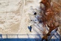 Kirov, Russia - March 23, 2019: Fisherman on the ice of the river on a sunny spring day. Top view of the ice of river or lake