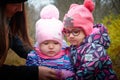 Kirov, Russia - October 23, 2022: Funny young small toddler children walking in beautiful autumn park on cold fall day