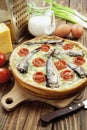 Kish with sprats and cherry tomatoes Royalty Free Stock Photo