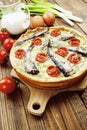 Kish with sprats and cherry tomatoes Royalty Free Stock Photo