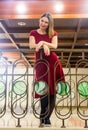 Kislovodsk, Russia. December 28, 2018. A beautiful woman in a red evening dress is standing on the stairs Royalty Free Stock Photo