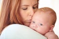 Kiss, baby and portrait with mother holding newborn in home for bonding together. Infant, face and mom carrying infant Royalty Free Stock Photo