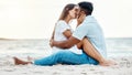 Kiss, beach and love of couple on a date for anniversary, valentines day or romance summer holiday with clear sky, ocean Royalty Free Stock Photo