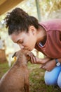 Kiss, dog and adoption with a black woman at a rescue shelter looking for a foster animal to love or care for. Kissing Royalty Free Stock Photo