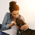 Kiss, dog and woman together on sofa or animal, happy owner and physical affection, love and hugs. Girl, canine and pet