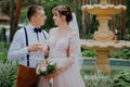 bride and groom with glasses of champagne in the park celebrate their wedding day. A loving couple of newlyweds drinks Royalty Free Stock Photo