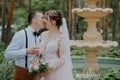 bride and groom with glasses of champagne in the park celebrate their wedding day. A loving couple of newlyweds drinks Royalty Free Stock Photo