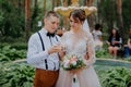 bride and groom with glasses of champagne in the park celebrate their wedding day. A loving couple of newlyweds drinks Royalty Free Stock Photo