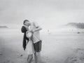 Kiss of a happy young romantic couple in love on the beach. Royalty Free Stock Photo