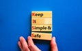 KISS keep it simple and safe symbol. Concept words KISS keep it simple and safe wooden blocks. Beautiful blue table, blue