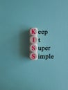 KISS keep it super and simple symbol. Concept red words KISS keep it super and simple wooden blocks.