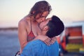 Kiss, love and couple at the beach on date, vacation or road trip in summer at sunset, together and romantic adventure Royalty Free Stock Photo