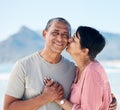 Kiss, love and mature couple outdoor at beach with a smile, care and happiness together in nature. Portrait of a happy Royalty Free Stock Photo