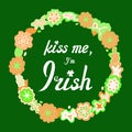 Kiss me, I am Irish. Joke, funny phrase, lettering in hand drawn floral wreath. Doodle on green background for prints Royalty Free Stock Photo