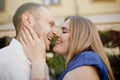 Happy couple in love hugging and kissing on the street old town. Royalty Free Stock Photo