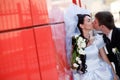 Kiss by the red wall Royalty Free Stock Photo