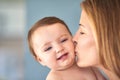 Kisses for mommys cutie. a mother kissing her adorable baby girl on the cheek. Royalty Free Stock Photo