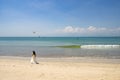 Kissing bride and groom with drone on beautiful beach, turquoise sea, Bali