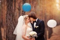 Kissing bride and groom in their wedding day near autumn tree in Royalty Free Stock Photo