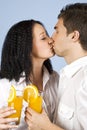 Kissing couple celebrate with fresh orange juice Royalty Free Stock Photo