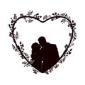 Kissing couple in the center of a heart decorated with wildflowers Royalty Free Stock Photo