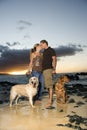 Kissing Couple With Dogs at the Beach Royalty Free Stock Photo